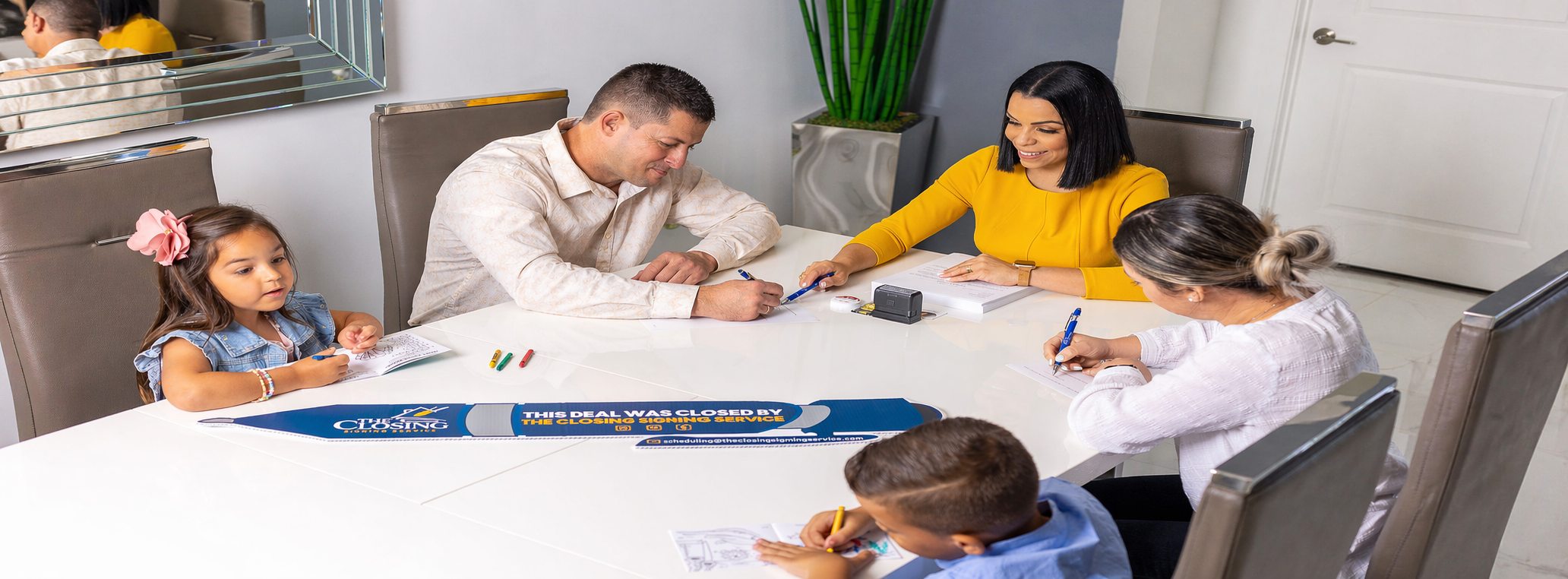 A family at their closing table with The Closing Signing Service